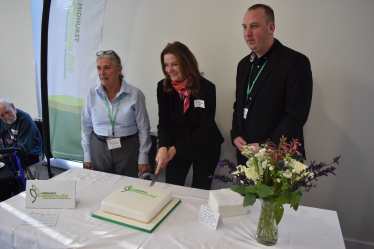 Gillian Cutting Cake at Event